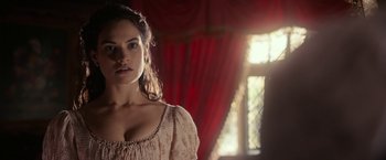 Movie still from “Pride and Prejudice and Zombies” (2016), directed by Burr Steers – A beautiful woman standing in front of a window; Close Up shot, Over the shoulder angle