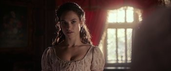 Movie still from “Pride and Prejudice and Zombies” (2016), directed by Burr Steers – A beautiful young lady wearing a white dress and looking at the camera; Close Up shot, Over the shoulder angle