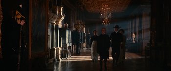 Movie still from “Pride and Prejudice and Zombies” (2016), directed by Burr Steers – A group of people walking down a hall way; Wide shot, Low angle