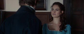 Movie still from “Pride and Prejudice and Zombies” (2016), directed by Burr Steers – A man and a woman standing next to each other in a room; Close Up shot, Over the shoulder angle