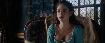 Movie still from “Pride and Prejudice and Zombies” (2016), directed by Burr Steers – A beautiful young woman sitting in a chair wearing a blue dress; Close Up shot, Over the shoulder angle