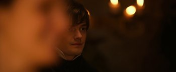 Movie still from “Pride and Prejudice and Zombies” (2016), directed by Burr Steers – A man with a beard and a black shirt; Close Up shot, Over the shoulder angle