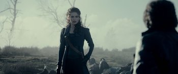 Movie still from “Pride and Prejudice and Zombies” (2016), directed by Burr Steers – A woman standing in the middle of a field; Medium shot, Over the shoulder angle
