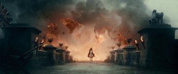 Movie still from “Pride and Prejudice and Zombies” (2016), directed by Burr Steers – A woman standing in front of a fire and smoke filled sky; Extreme Wide shot, Low angle