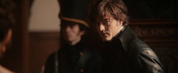 Movie still from “Pride and Prejudice and Zombies” (2016), directed by Burr Steers – A man in a black jacket and a man in a black suit; Close Up shot, Over the shoulder angle