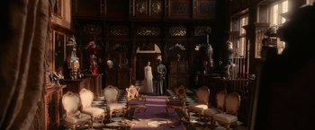 Movie still from “Pride and Prejudice and Zombies” (2016), directed by Burr Steers – Two people standing in a room with a purple carpet; Wide shot, High angle