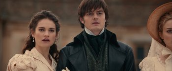 Movie still from “Pride and Prejudice and Zombies” (2016), directed by Burr Steers – A man and a woman standing next to each other in front of a brick wall; Close Up shot, Over the shoulder angle