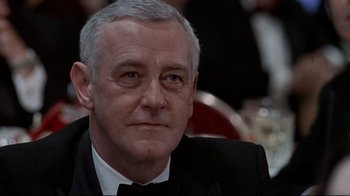 Movie still from “Primal Fear” (1996), directed by Gregory Hoblit – An older man in a tuxedo looking at the camera; Close Up shot, Low angle