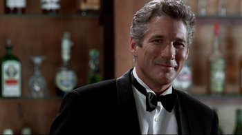 Movie still from “Primal Fear” (1996), directed by Gregory Hoblit – A person wearing a suit and a bow tie; Close Up shot, Low angle