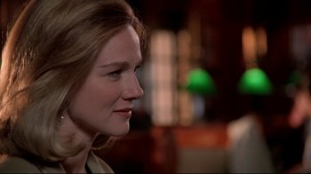 Movie still from “Primal Fear” (1996), directed by Gregory Hoblit – A woman's face in a dark room; Close Up shot, Over the shoulder angle