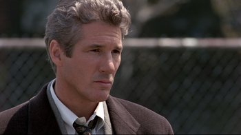 Movie still from “Primal Fear” (1996), directed by Gregory Hoblit – A person wearing a suit and tie; Close Up shot, Over the shoulder angle