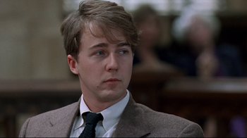 Movie still from “Primal Fear” (1996), directed by Gregory Hoblit – A man in a suit and tie looking to his left; Close Up shot, Low angle