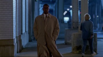 Movie still from “Primal Fear” (1996), directed by Gregory Hoblit – A man standing in the street wearing a coat and tie; Wide shot, Low angle