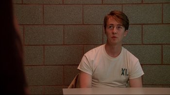 Movie still from “Primal Fear” (1996), directed by Gregory Hoblit – A man sitting in front of a brick wall; Medium shot, Over the shoulder angle