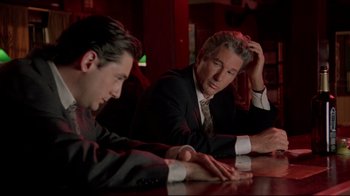 Movie still from “Primal Fear” (1996), directed by Gregory Hoblit – Two men sitting at a table in a dark room; Medium shot, Over the shoulder angle