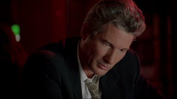 Movie still from “Primal Fear” (1996), directed by Gregory Hoblit – A person wearing a suit and tie; Close Up shot, Over the shoulder angle