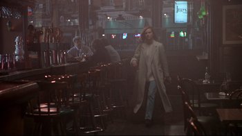 Movie still from “Primal Fear” (1996), directed by Gregory Hoblit – A woman in a white coat walking through a restaurant; Wide shot, Over the shoulder angle
