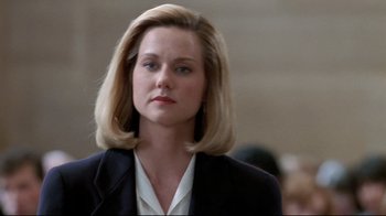 Movie still from “Primal Fear” (1996), directed by Gregory Hoblit – A woman with blonde hair wearing a black jacket; Close Up shot, Low angle