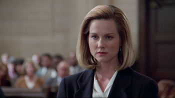 Movie still from “Primal Fear” (1996), directed by Gregory Hoblit – A woman in a black suit and white shirt; Close Up shot, Low angle