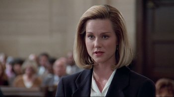 Movie still from “Primal Fear” (1996), directed by Gregory Hoblit – A woman with blonde hair wearing a black suit; Close Up shot, Low angle