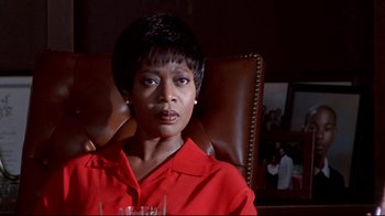Movie still from “Primal Fear” (1996), directed by Gregory Hoblit – A woman sitting in a chair holding a wine glass; Close Up shot, Low angle
