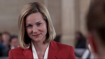 Movie still from “Primal Fear” (1996), directed by Gregory Hoblit – A person wearing a suit and smiling; Close Up shot, Low angle