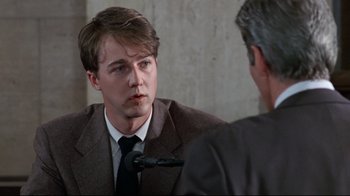 Movie still from “Primal Fear” (1996), directed by Gregory Hoblit – A man in a suit and tie talking to another man in a suit and tie; Close Up shot, Over the shoulder angle