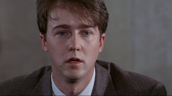 Movie still from “Primal Fear” (1996), directed by Gregory Hoblit – A person wearing a suit and tie; Close Up shot, Over the shoulder angle