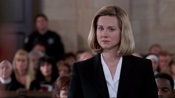 Movie still from “Primal Fear” (1996), directed by Gregory Hoblit – A woman in a black suit and white shirt; Close Up shot, Low angle