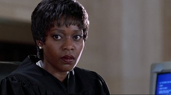 Movie still from “Primal Fear” (1996), directed by Gregory Hoblit – A woman in a judge's robe looking at the camera; Close Up shot, Low angle