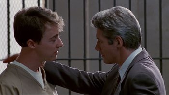 Movie still from “Primal Fear” (1996), directed by Gregory Hoblit – A man and a man in a suit and tie touching each other; Close Up shot, Low angle