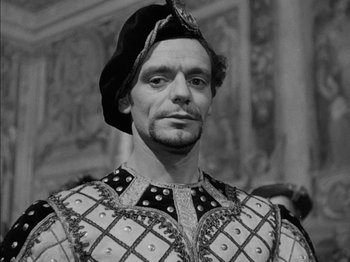 Movie still from “Prince of Foxes” (1949), directed by Henry King – A black and white photo of a man in a costume; Close Up shot, High angle