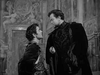 Movie still from “Prince of Foxes” (1949), directed by Henry King – Two men in medieval garb talking to each other; Medium shot, Low angle