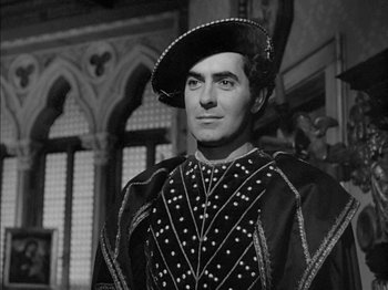 Movie still from “Prince of Foxes” (1949), directed by Henry King – A black and white photo of a man wearing a hat; Medium shot, Over the shoulder angle