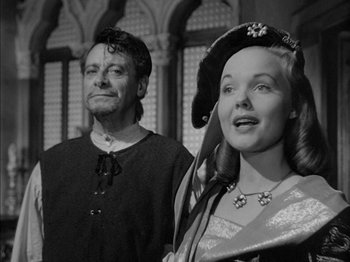 Movie still from “Prince of Foxes” (1949), directed by Henry King – A man and a woman standing next to each other in front of a building; Medium shot, Low angle