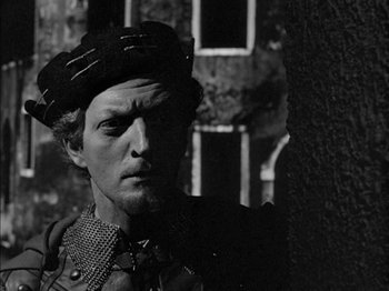 Movie still from “Prince of Foxes” (1949), directed by Henry King – A black and white photo of a man wearing a hat; Close Up shot, High angle