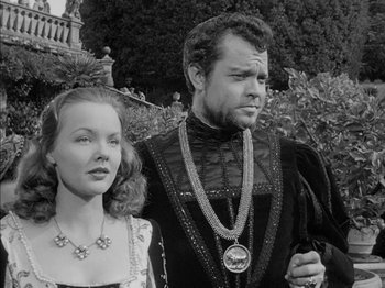Movie still from “Prince of Foxes” (1949), directed by Henry King – A man and a woman dressed in medieval garb standing next to each other; Medium shot, Over the shoulder angle