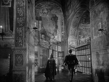 Movie still from “Prince of Foxes” (1949), directed by Henry King – Two people walking down a hall way in a building; Extreme Wide shot, Low angle