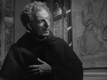 Movie still from “Prince of Foxes” (1949), directed by Henry King – A man in a monk's robe is looking at the camera; Medium shot, Low angle