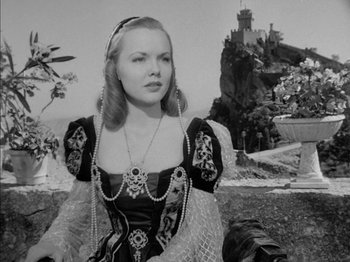 Movie still from “Prince of Foxes” (1949), directed by Henry King – A black and white photo of a woman in a medieval dress; Medium shot, Low angle