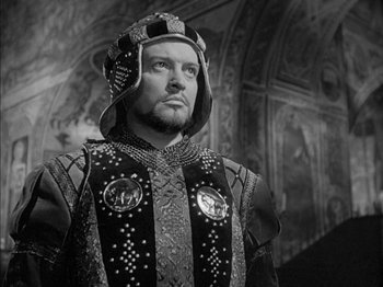 Movie still from “Prince of Foxes” (1949), directed by Henry King – A black and white photo of a man wearing a helmet; Close Up shot, High angle