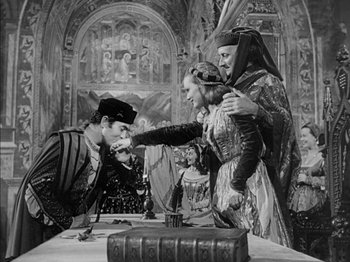 Movie still from “Prince of Foxes” (1949), directed by Henry King – A group of people standing next to each other on top of a table; Medium shot, High angle