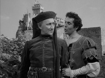 Movie still from “Prince of Foxes” (1949), directed by Henry King – Two men in medieval garb standing next to each other; Medium shot, Over the shoulder angle