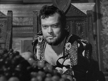 Movie still from “Prince of Foxes” (1949), directed by Henry King – A black and white photo of a man sitting in a chair; Close Up shot, Low angle