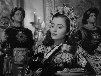 Movie still from “Prince of Foxes” (1949), directed by Henry King – A woman in a crown and a man in a black suit; Medium shot, Over the shoulder angle