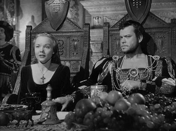Movie still from “Prince of Foxes” (1949), directed by Henry King – A man and a woman sitting at a dinner table; Medium shot, High angle