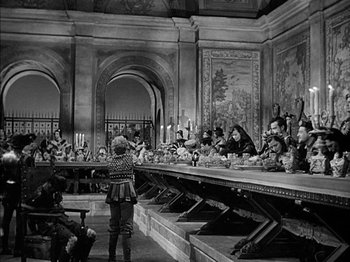 Movie still from “Prince of Foxes” (1949), directed by Henry King – A group of people sitting around a table; Wide shot, High angle