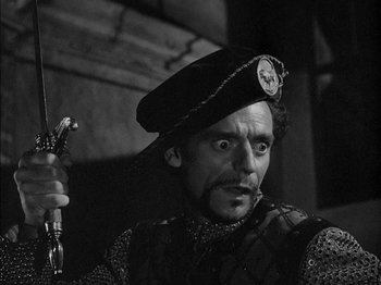 Movie still from “Prince of Foxes” (1949), directed by Henry King – A man in a black hat holding a sword; Close Up shot, High angle