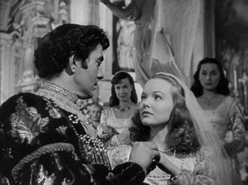 Movie still from “Prince of Foxes” (1949), directed by Henry King – A man and a woman in medieval garb in front of a crowd; Medium shot, Over the shoulder angle