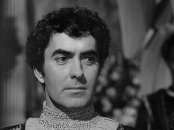 Movie still from “Prince of Foxes” (1949), directed by Henry King – A black and white photo of a man in a renaissance costume; Close Up shot, High angle